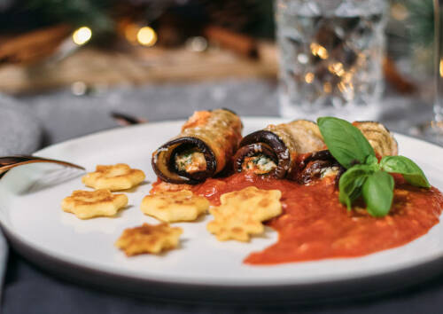 Aubergineninvoltini mit Spinat-Ricottafüllung, dazu Gnocchi-Sterne und eine leckere Tomatensauce. Von der Seite fotografiert.