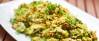 Couscous auf weißem Teller mit Zucchini, Champignons und Curry